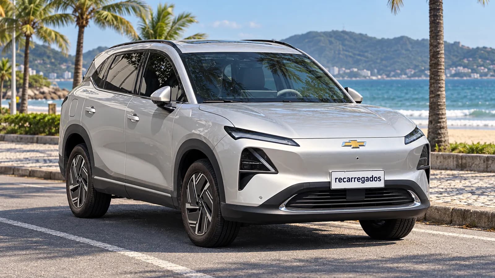 Chevrolet Captiva EV prata em avenida à beira-mar em Florianópolis, imagem gerada com IA a partir de foto real